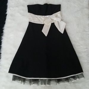 Black short strapless dress.